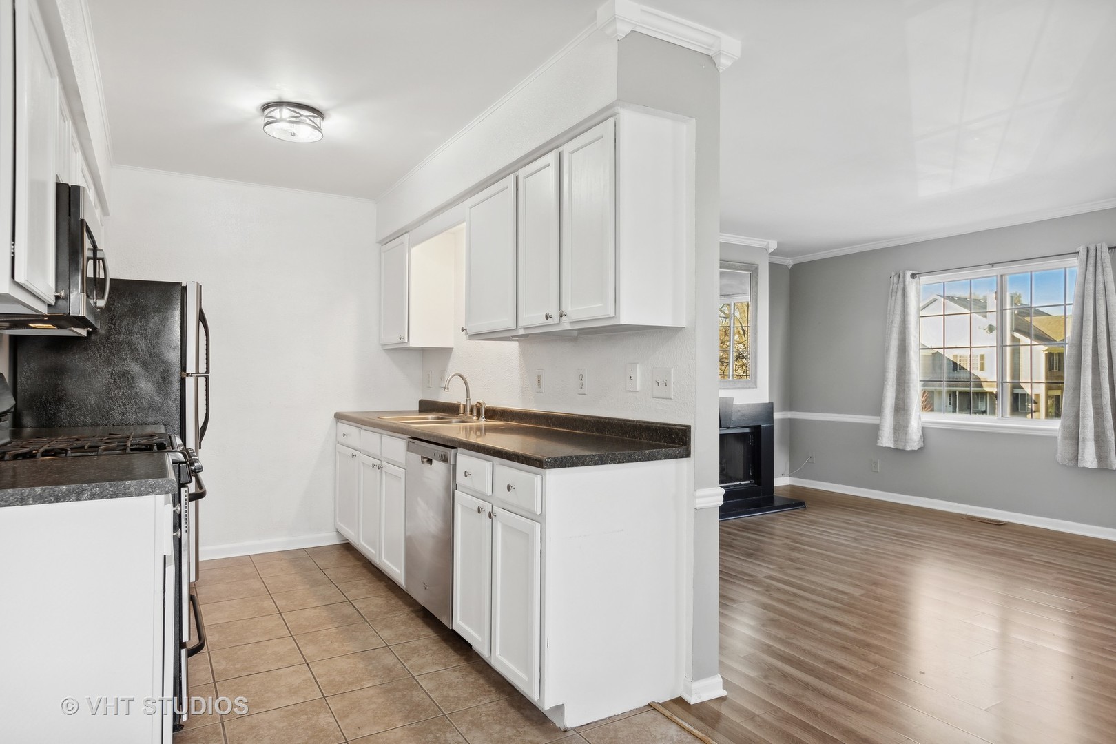 618 Silver Creek Road, Unit 618 Woodstock, IL 60098 - Photo 7 of 21 a kitchen with stainless steel appliances granite countertop a stove a sink and a refrigerator