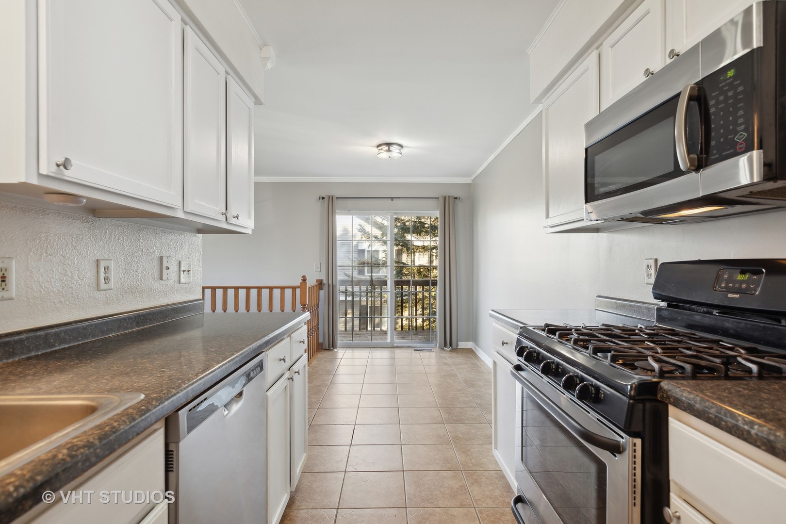 618 Silver Creek Road, Unit 618 Woodstock, IL 60098 - Photo 8 of 21 a kitchen with stainless steel appliances granite countertop a sink stove and microwave