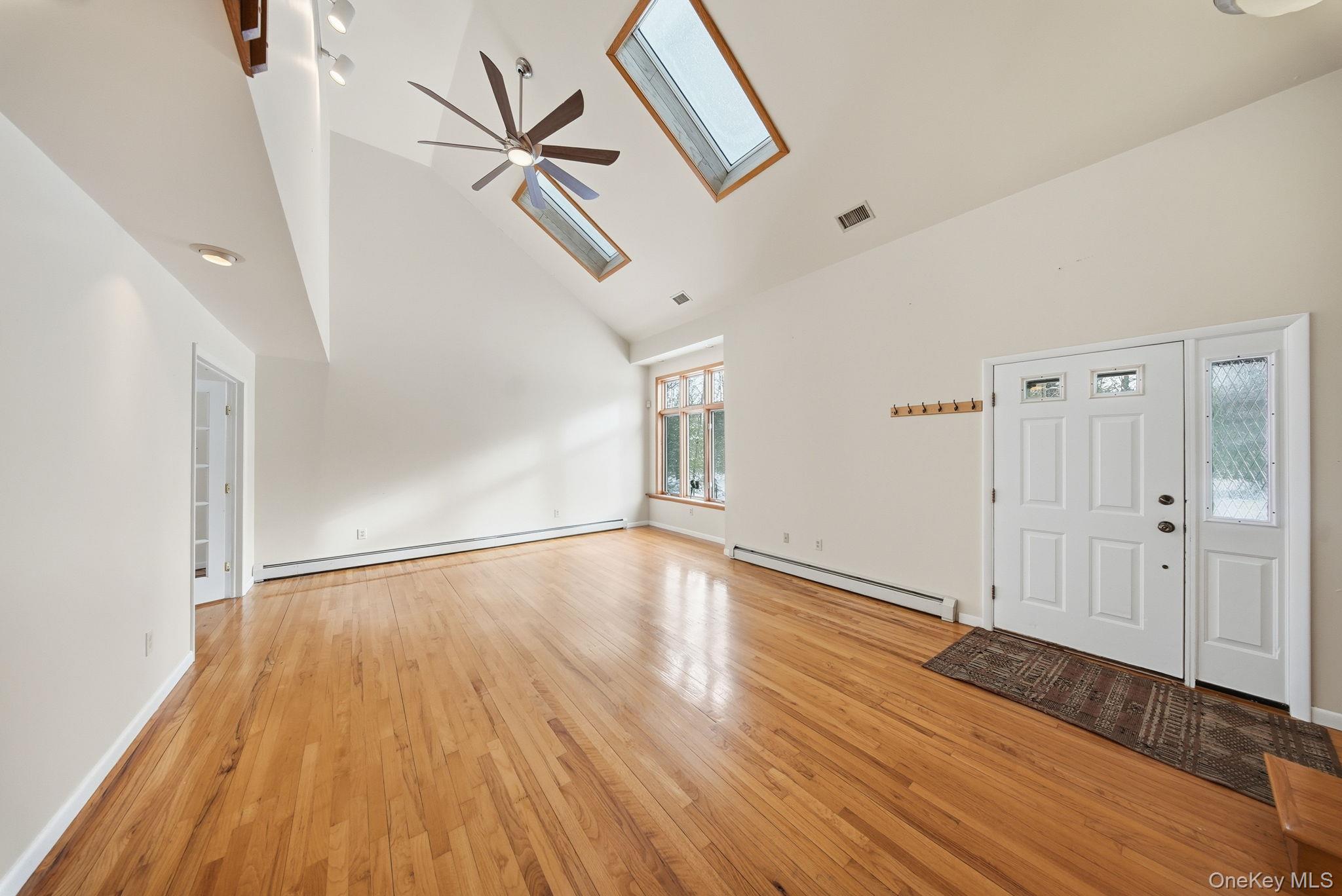 139 Renner Road Mountain Dale, NY 12763 - Photo 9 of 50 a view of an empty room with wooden floor and a ceiling fan