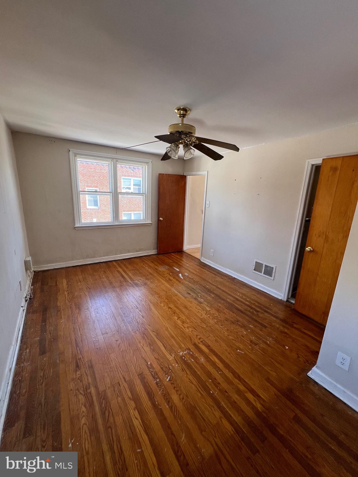 7238 Dungan Road Philadelphia, PA 19111 - Photo 6 of 15 wooden floor in an empty room with a window