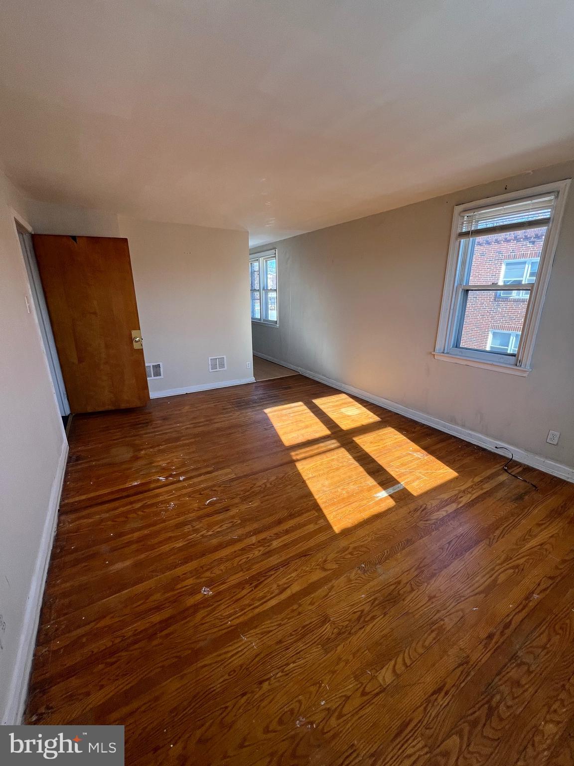 7238 Dungan Road Philadelphia, PA 19111 - Photo 10 of 15 an empty room with wooden floor and windows