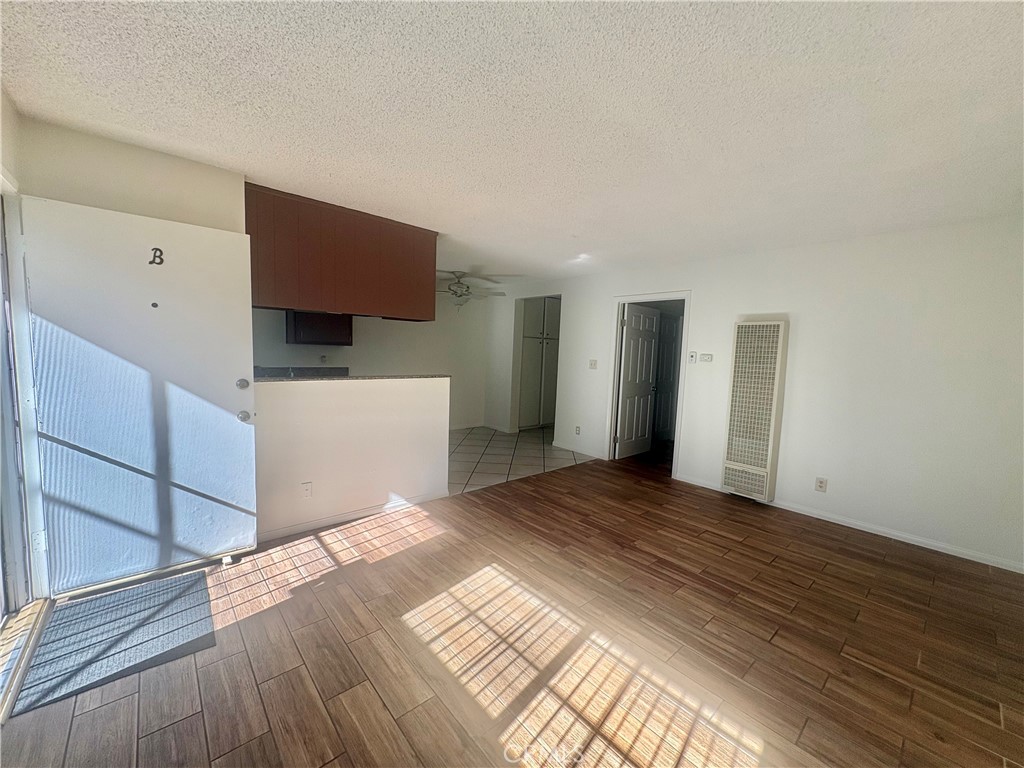 11751 Colima Road, Unit B Whittier, CA 90604 - Photo 2 of 12 a view of a kitchen with wooden floor and electronic appliances