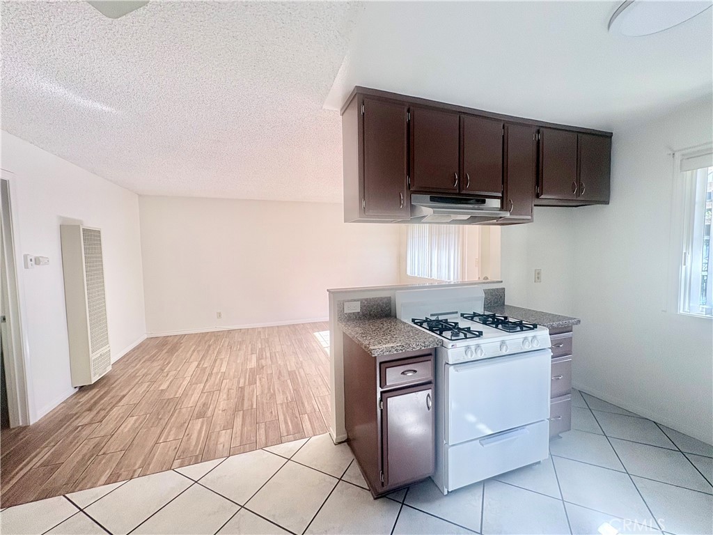 11751 Colima Road, Unit B Whittier, CA 90604 - Photo 5 of 12 a kitchen with a stove and a microwave