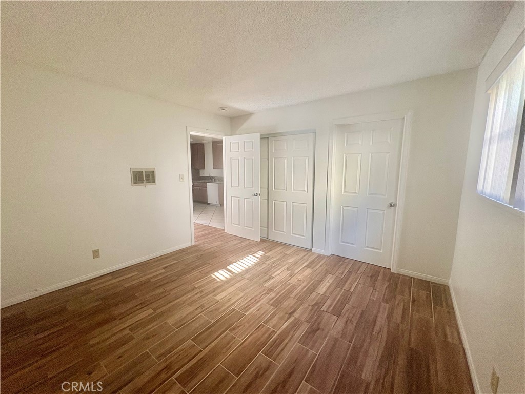 11751 Colima Road, Unit B Whittier, CA 90604 - Photo 6 of 12 a view of an empty room with wooden floor and window