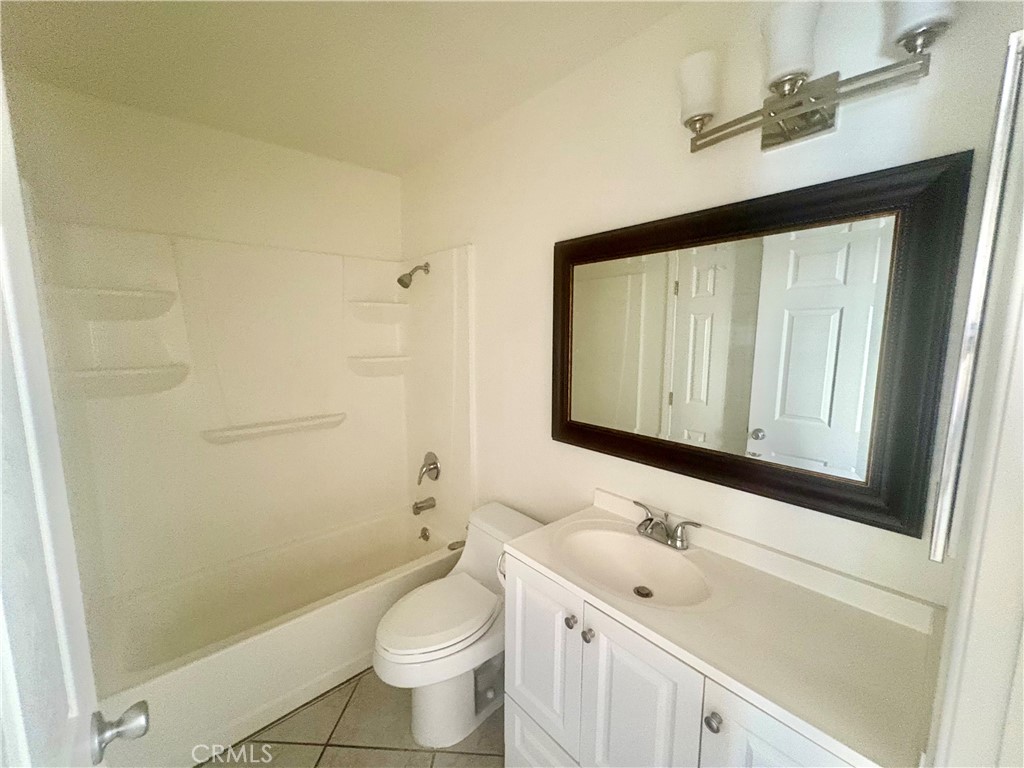 11751 Colima Road, Unit B Whittier, CA 90604 - Photo 9 of 12 a bathroom with a sink a toilet and a mirror