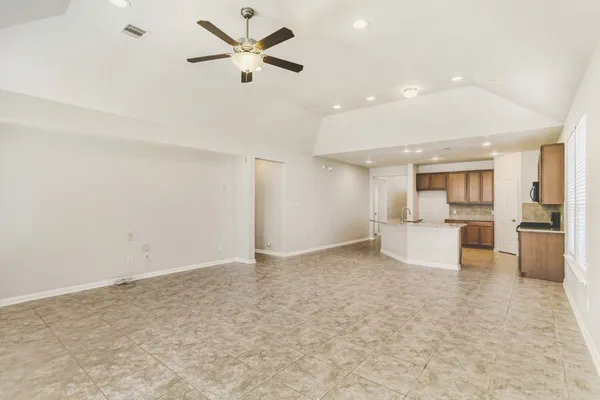a view of a kitchen with a sink and refrigerator
