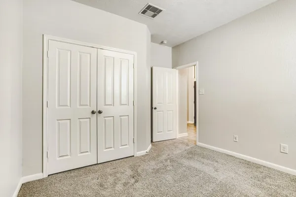 an empty room with closet area