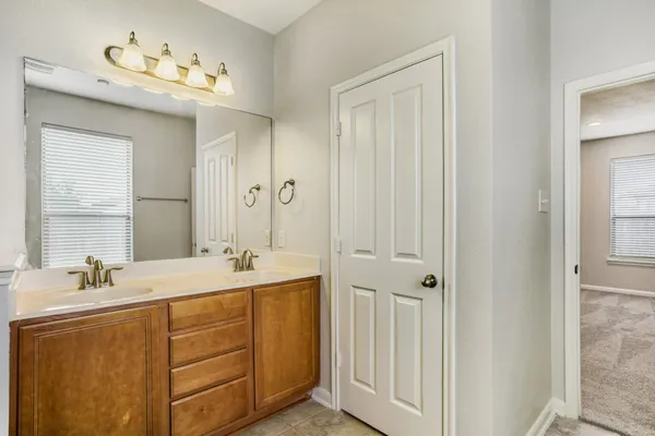 a bathroom with a double vanity sink mirror and double