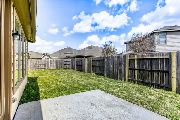 a view of a backyard with wooden fence