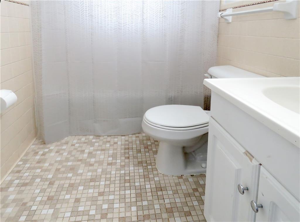 4672 Vernon Drive Southwest Mableton, GA 30126 - Photo 25 of 42 a bathroom with a sink a toilet and a mirror