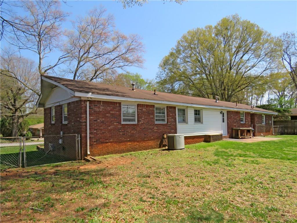 4672 Vernon Drive Southwest Mableton, GA 30126 - Photo 37 of 42 a front view of house with yard and trees in the background