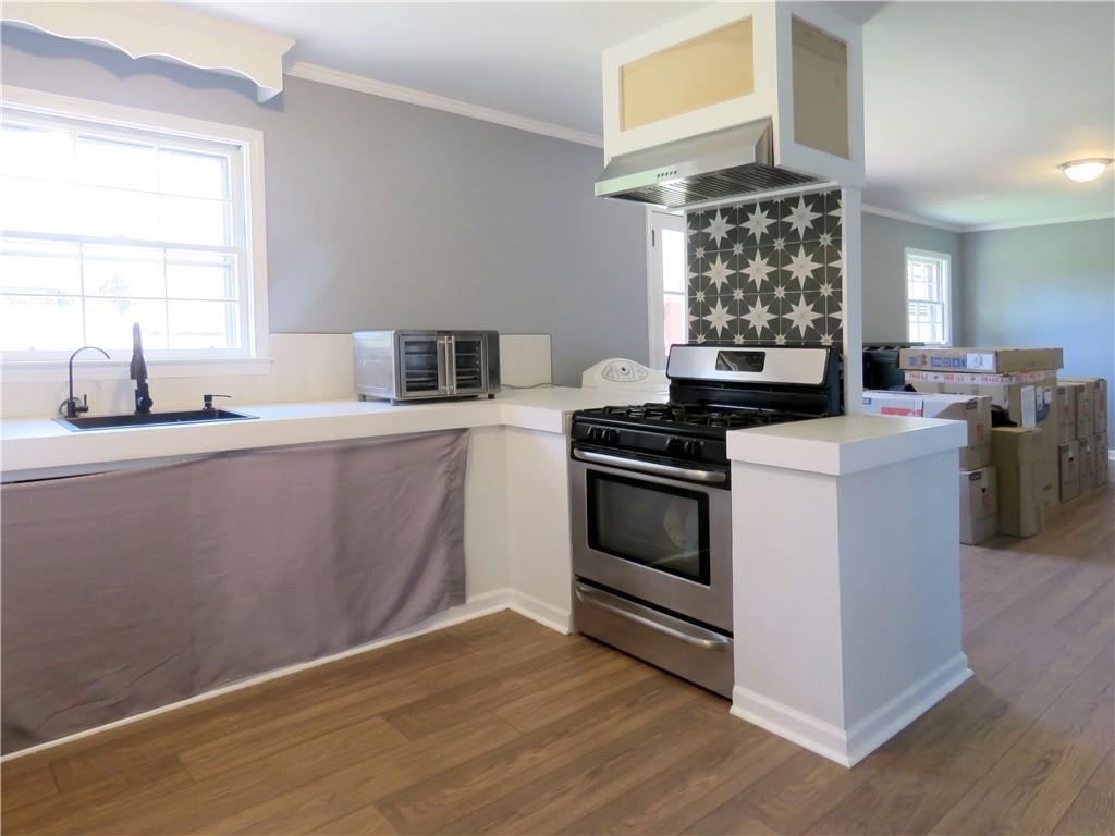 4672 Vernon Drive Southwest Mableton, GA 30126 - Photo 5 of 42 a kitchen with granite countertop a sink cabinets and wooden floor