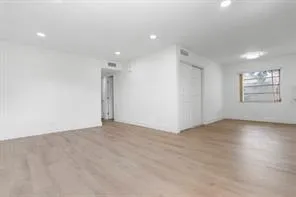 an empty room with windows and closet