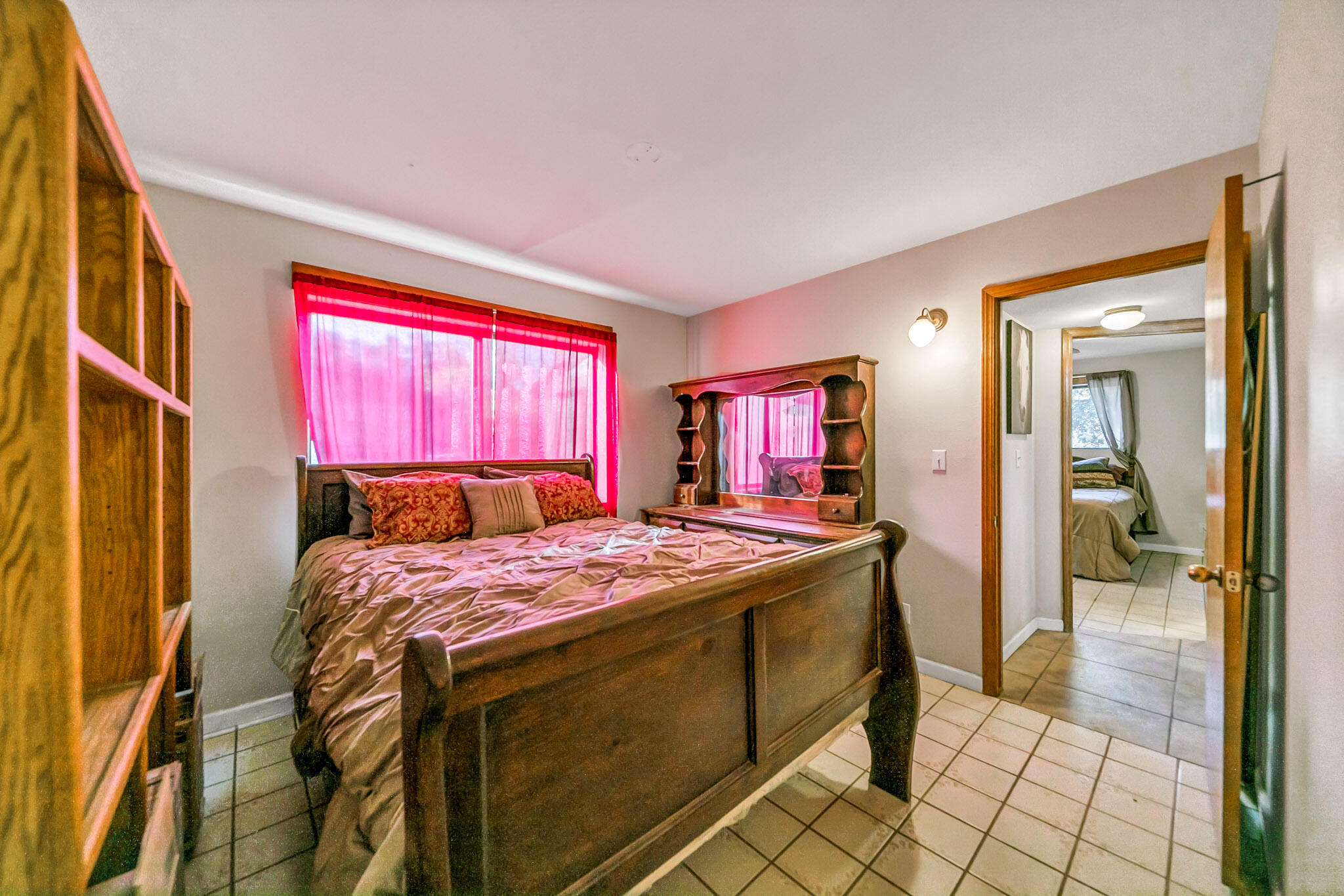 26051 Cumberland Road Tehachapi, CA 93561 - Photo 22 of 46 a bedroom with a bed and a chandelier