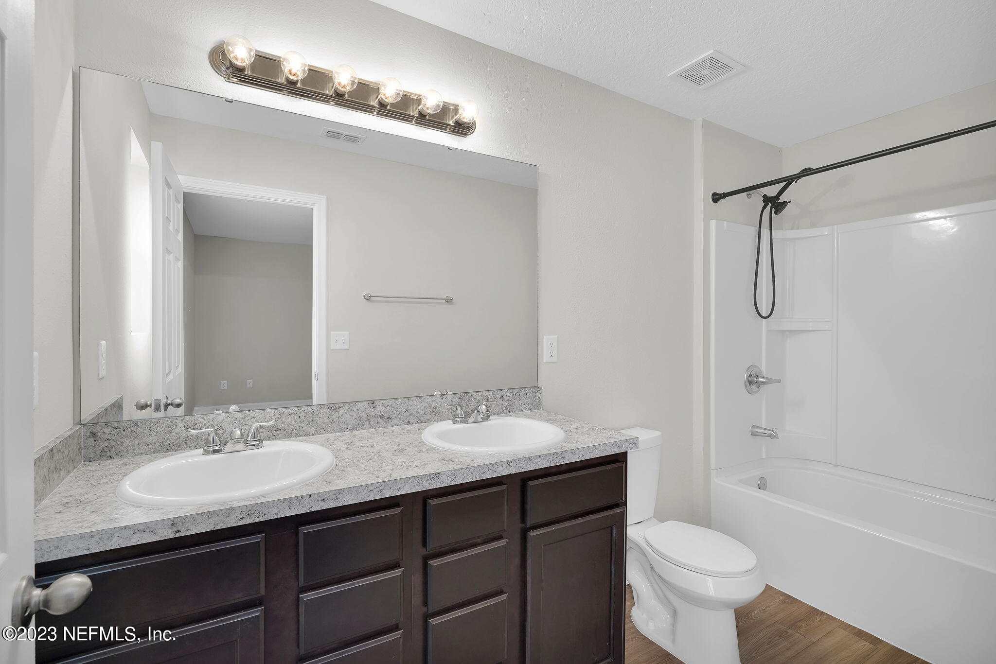 3082 Jennings Road Jacksonville, FL 32218 - Photo 11 of 17 a bathroom with a granite countertop sink toilet a shower and a mirror