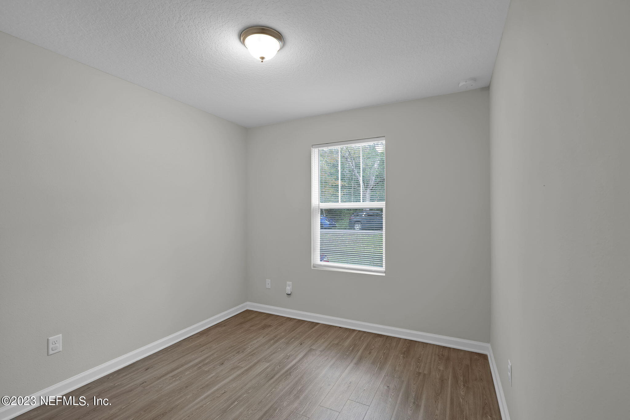 3082 Jennings Road Jacksonville, FL 32218 - Photo 13 of 17 an empty room with wooden floor and windows