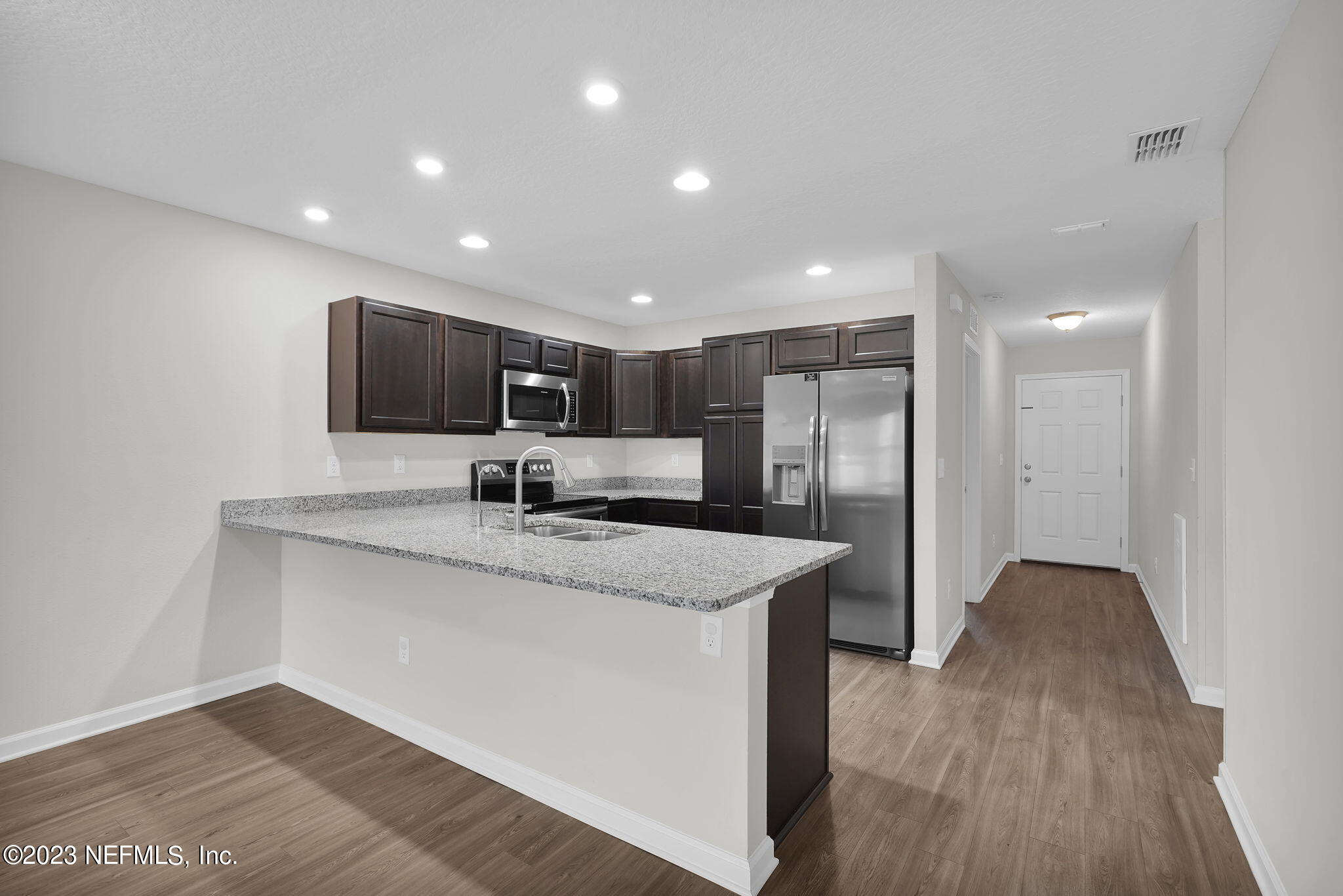 3082 Jennings Road Jacksonville, FL 32218 - Photo 3 of 17 a kitchen with stainless steel appliances granite countertop a sink a microwave a refrigerator and a microwave