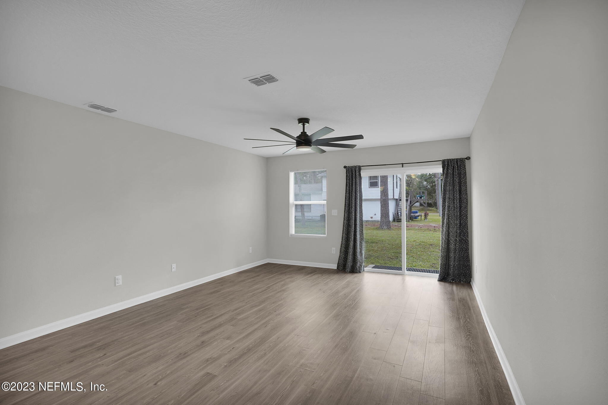 3082 Jennings Road Jacksonville, FL 32218 - Photo 4 of 17 wooden floor in an empty room with a window