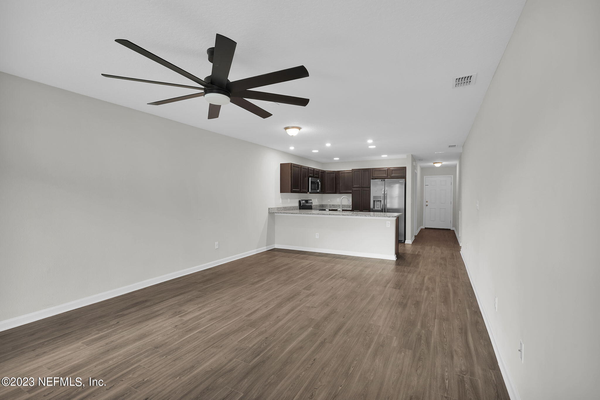 3082 Jennings Road Jacksonville, FL 32218 - Photo 6 of 17 a view of a kitchen with wooden floor and a ceiling fan