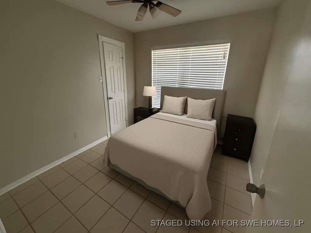 3 John Kay Road Huntsville, TX 77320 - Photo 14 of 23 a bedroom with a bed and a chandelier