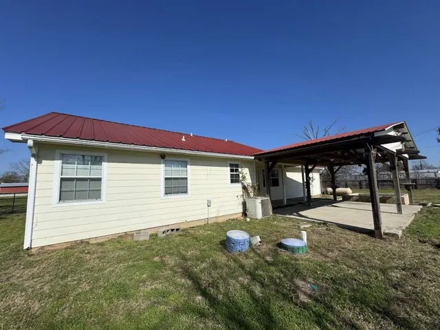 a backyard of a house with table and chairs