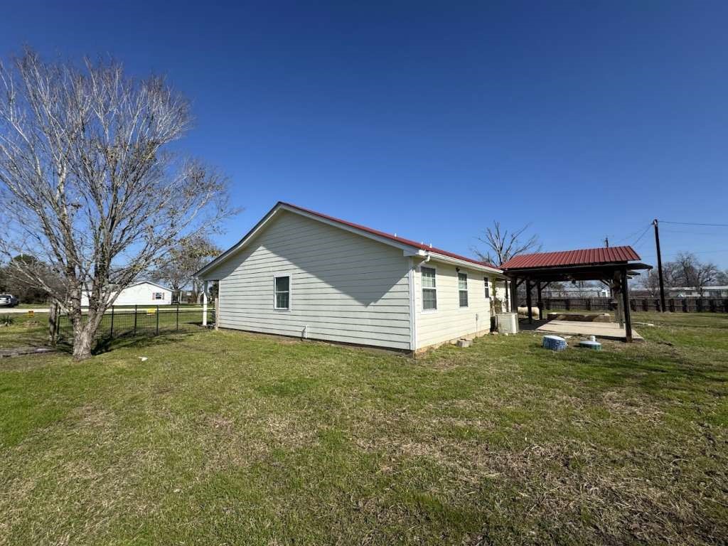 3 John Kay Road Huntsville, TX 77320 - Photo 23 of 23 a house that is sitting in the grass with large trees