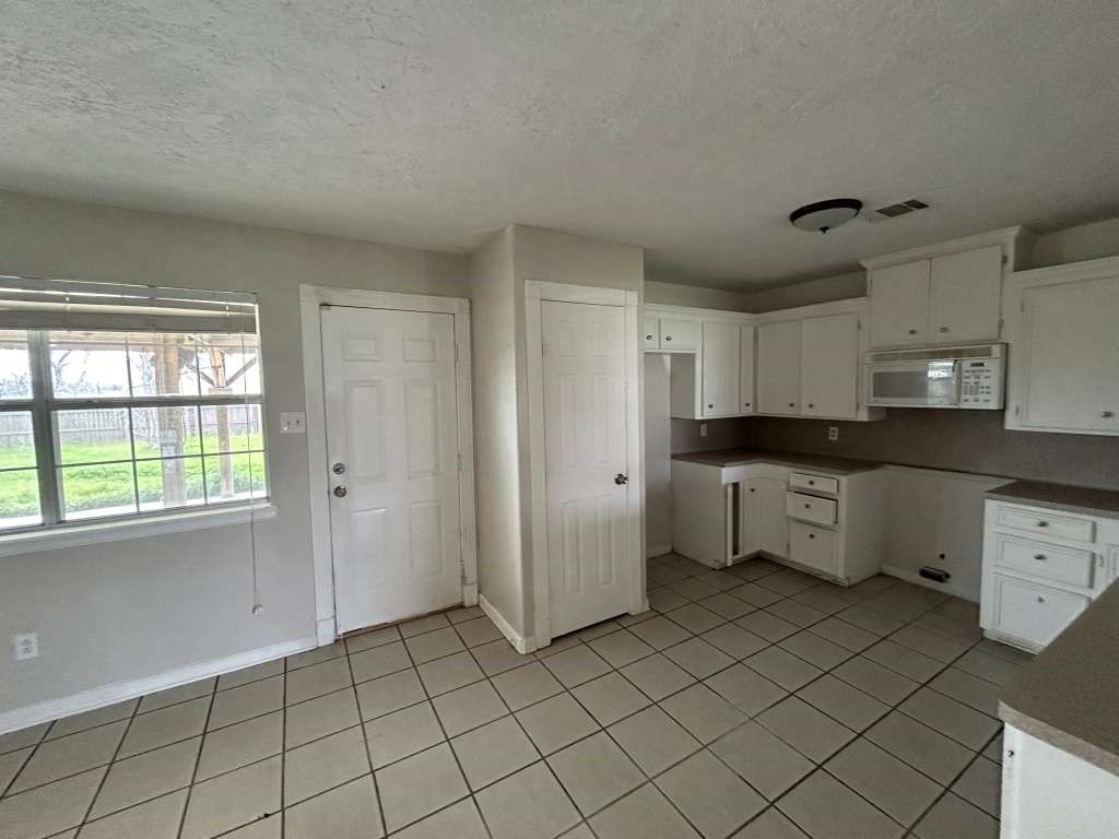 3 John Kay Road Huntsville, TX 77320 - Photo 8 of 23 a kitchen with a cabinets and window
