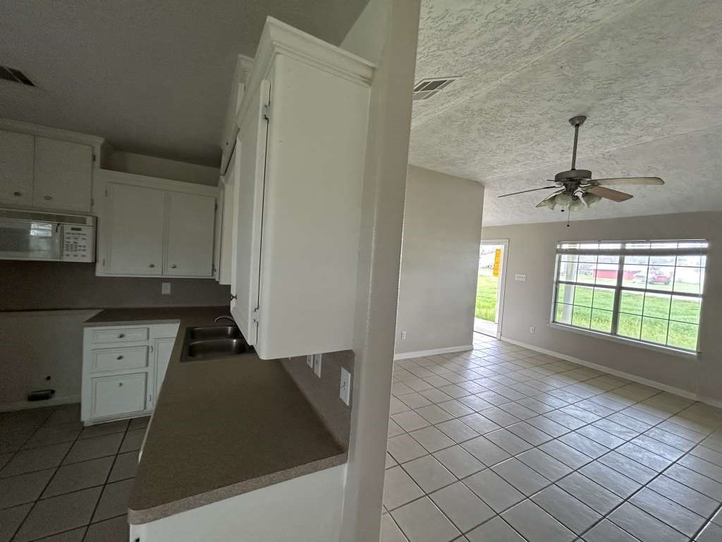 3 John Kay Road Huntsville, TX 77320 - Photo 10 of 23 a view of a kitchen with a sink and dishwasher cabinets