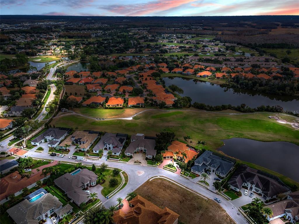 10610 Sabella Drive Trinity, FL 34655 - Photo 4 of 46 a view of a lake with a table and chairs under an umbrella