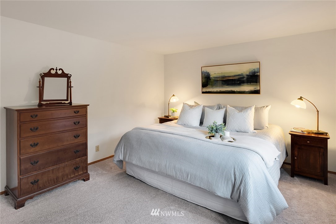 21031 Shell Valley Way Edmonds, WA 98026 - Photo 16 of 32 a bedroom with a bed and a lamp on dresser