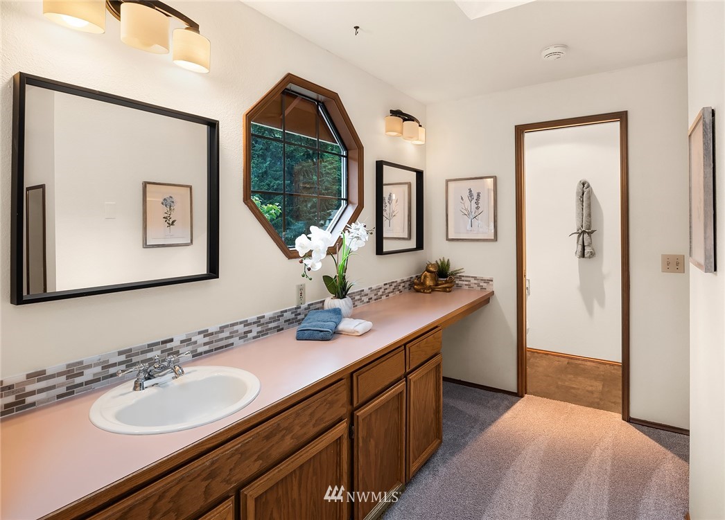 21031 Shell Valley Way Edmonds, WA 98026 - Photo 18 of 32 a en suite bathroom with a granite countertop sink and a mirror