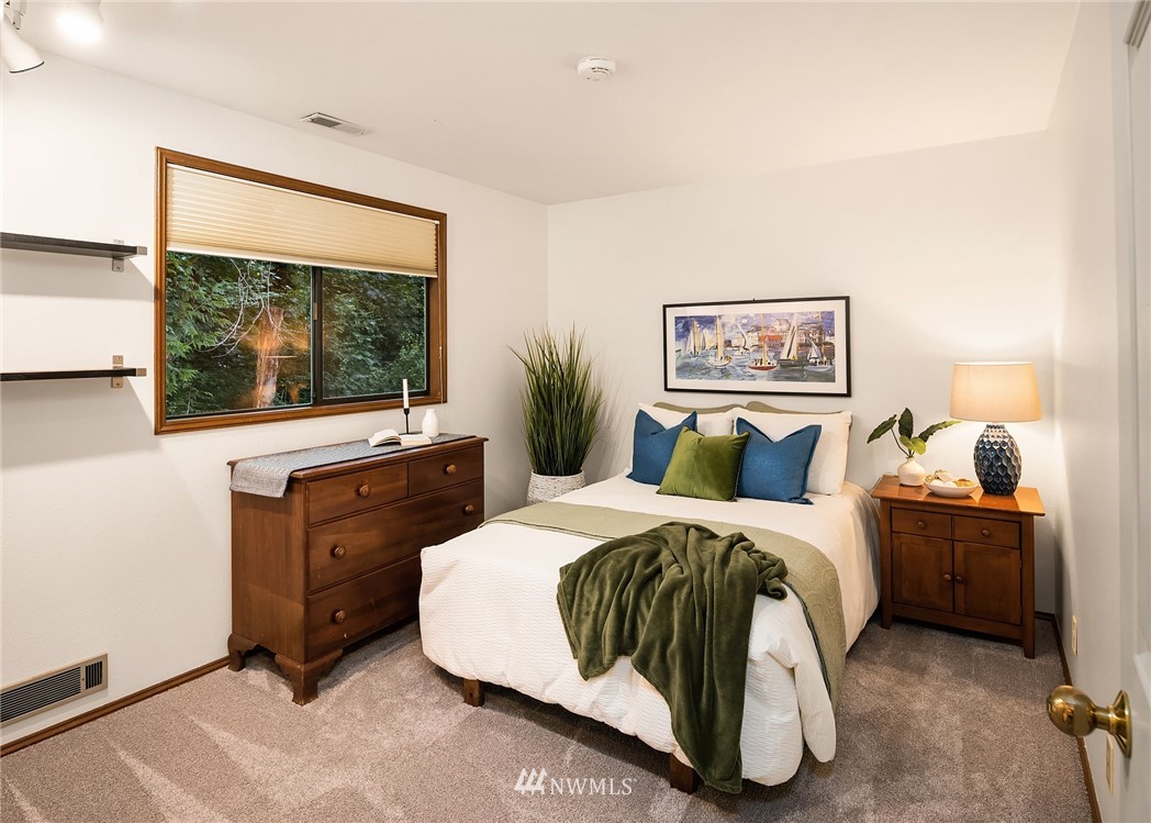 21031 Shell Valley Way Edmonds, WA 98026 - Photo 20 of 32 a bedroom with a bed and a flat tv screen on dresser