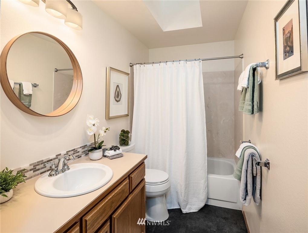 21031 Shell Valley Way Edmonds, WA 98026 - Photo 21 of 32 a bathroom with a granite countertop sink toilet and a mirror