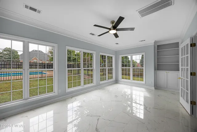 a view of an empty room with a window and balcony