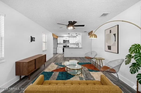 a living room with furniture fireplace and potted plant