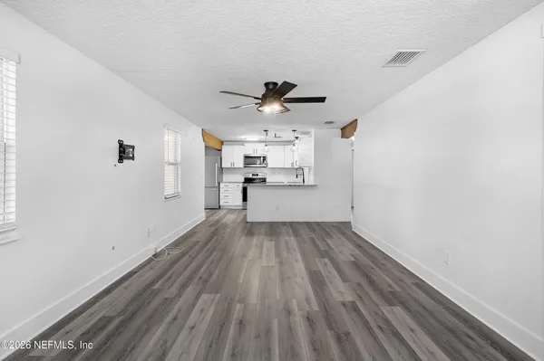 a kitchen with stainless steel appliances a refrigerator and a stove top oven