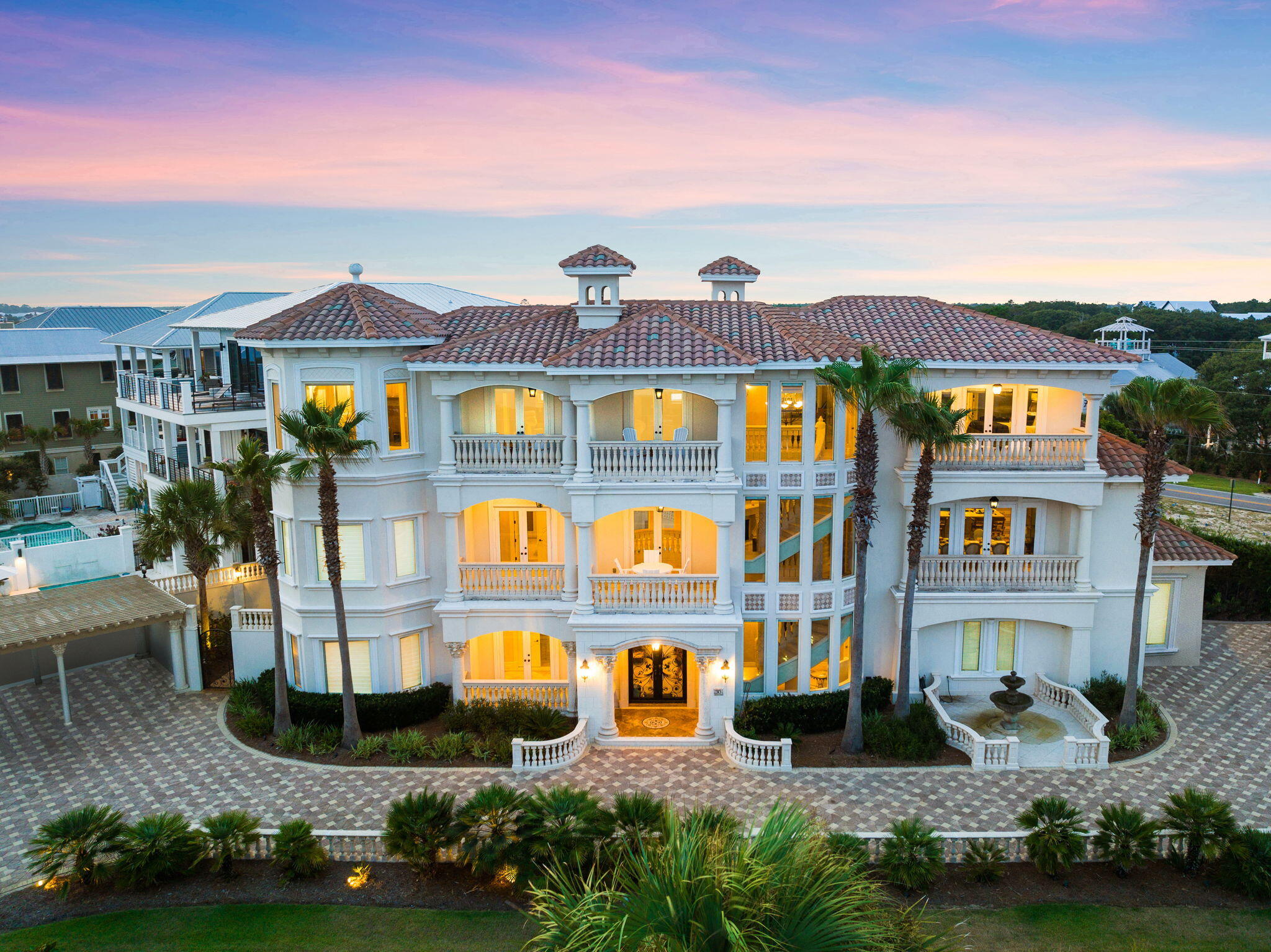 a front view of a building with glass windows and yard
