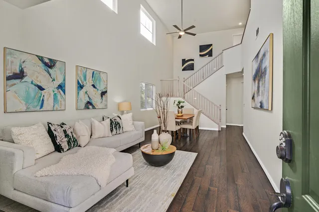 a living room with furniture and wooden floor