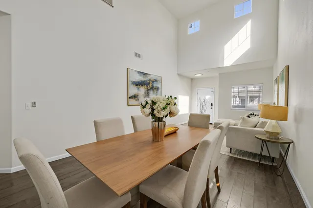 a dining room with furniture and wooden floor
