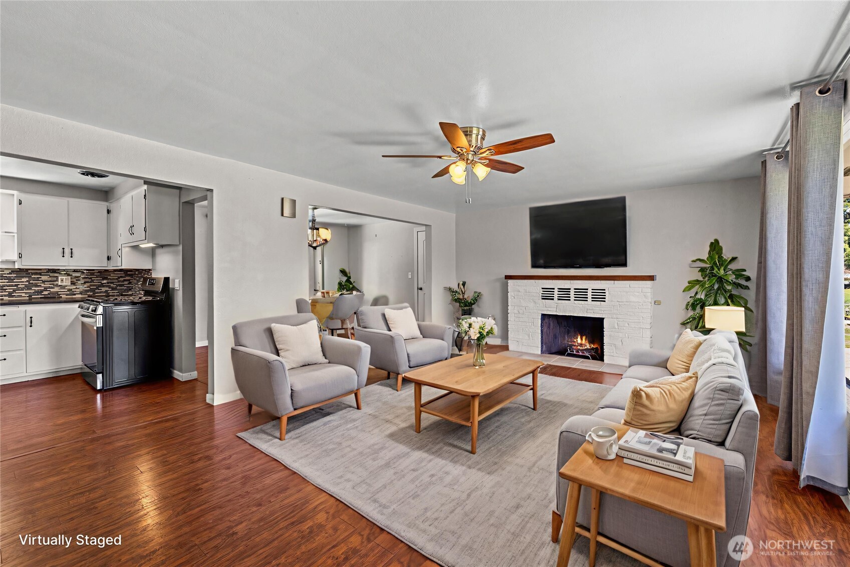 10450 Sterling Road Sedro-Woolley, WA 98284 - Photo 11 of 33 a living room with furniture a fireplace and a flat screen tv