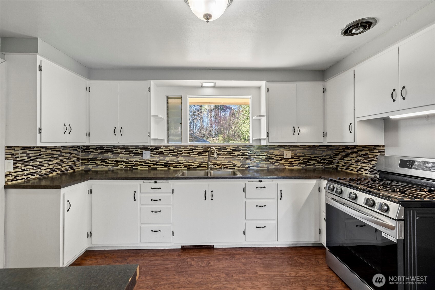 10450 Sterling Road Sedro-Woolley, WA 98284 - Photo 13 of 33 a kitchen with granite countertop white cabinets and white appliances