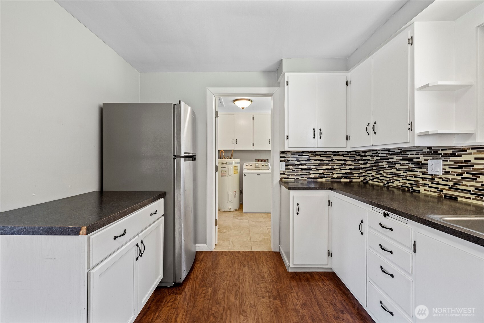 10450 Sterling Road Sedro-Woolley, WA 98284 - Photo 16 of 33 a kitchen with granite countertop white cabinets and refrigerator