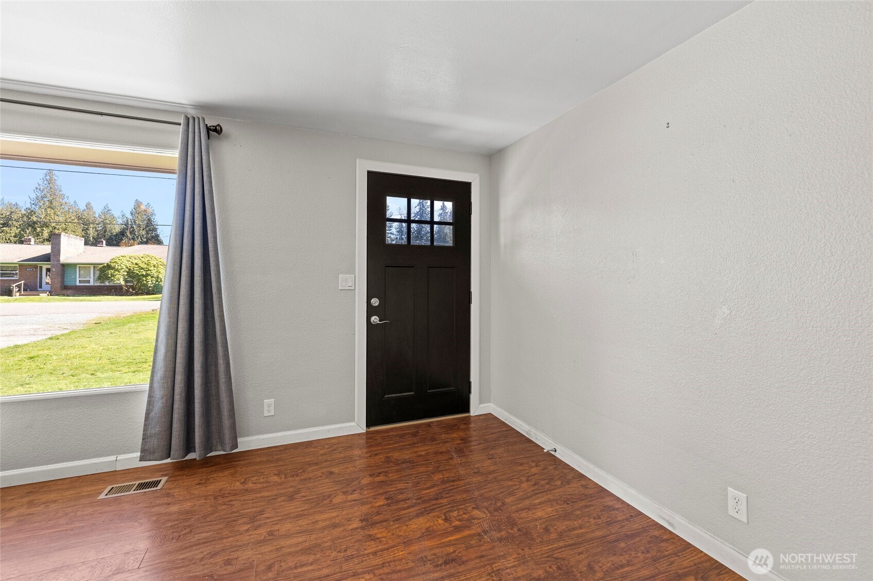 10450 Sterling Road Sedro-Woolley, WA 98284 - Photo 9 of 33 an empty room with wooden floor and a window