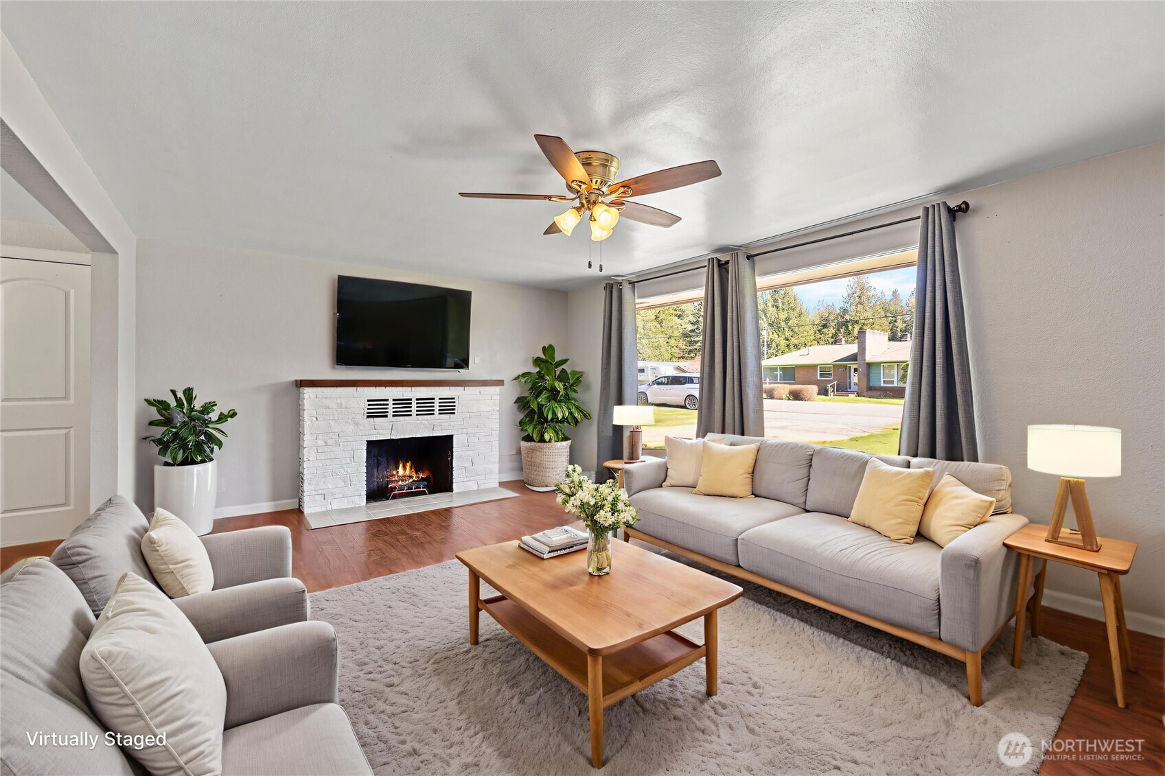 10450 Sterling Road Sedro-Woolley, WA 98284 - Photo 10 of 33 a living room with furniture a fireplace and a flat screen tv