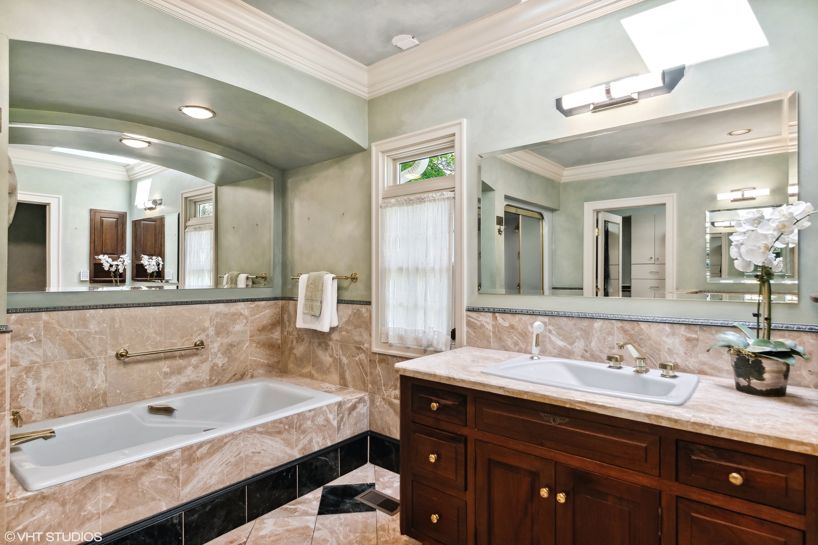 916 Shermer Road Northbrook, IL 60062 - Photo 27 of 54 a bathroom with a bathtub double sink and mirror