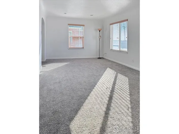 a view of an empty room with windows