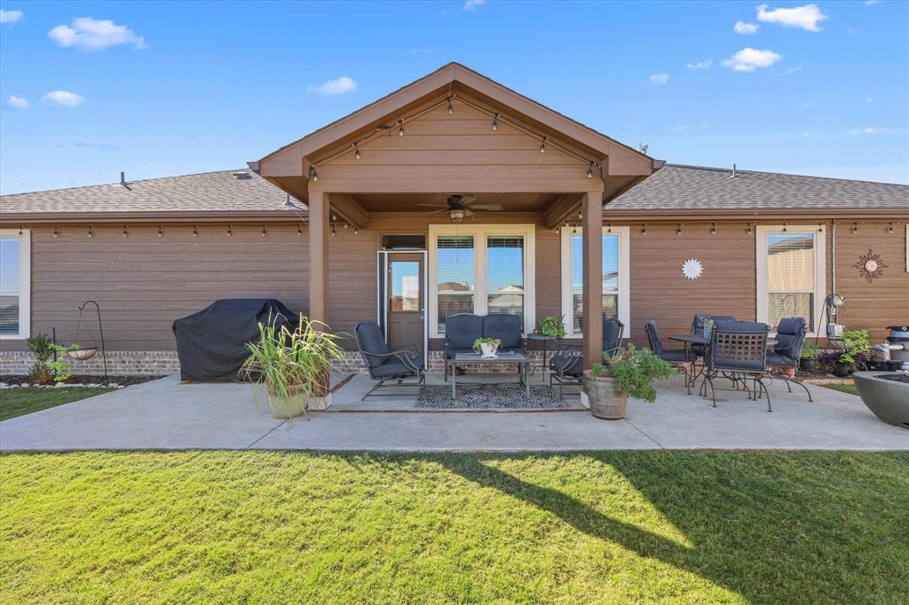 2375 County Road 4010 Decatur, TX 76234 - Photo 18 of 34 Rear view of property featuring a ceiling fan, a patio area, and a shingled roof