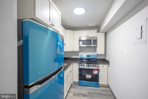a kitchen with stainless steel appliances granite countertop a stove a refrigerator and a sink