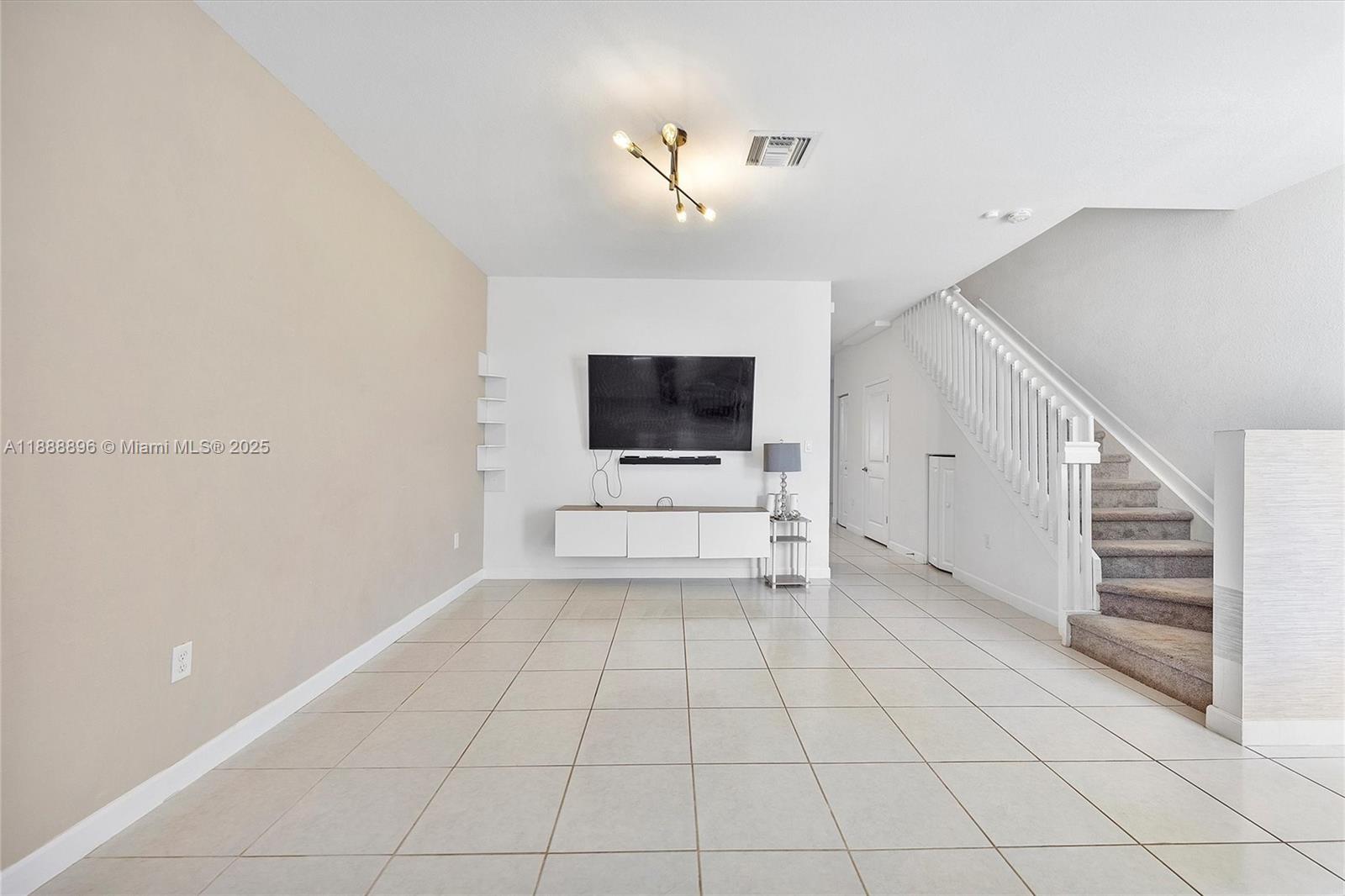 10013 Southwest 228th Terrace, Unit 10013 Miami, FL 33190 - Photo 1 of 39 a view of an empty room with a window