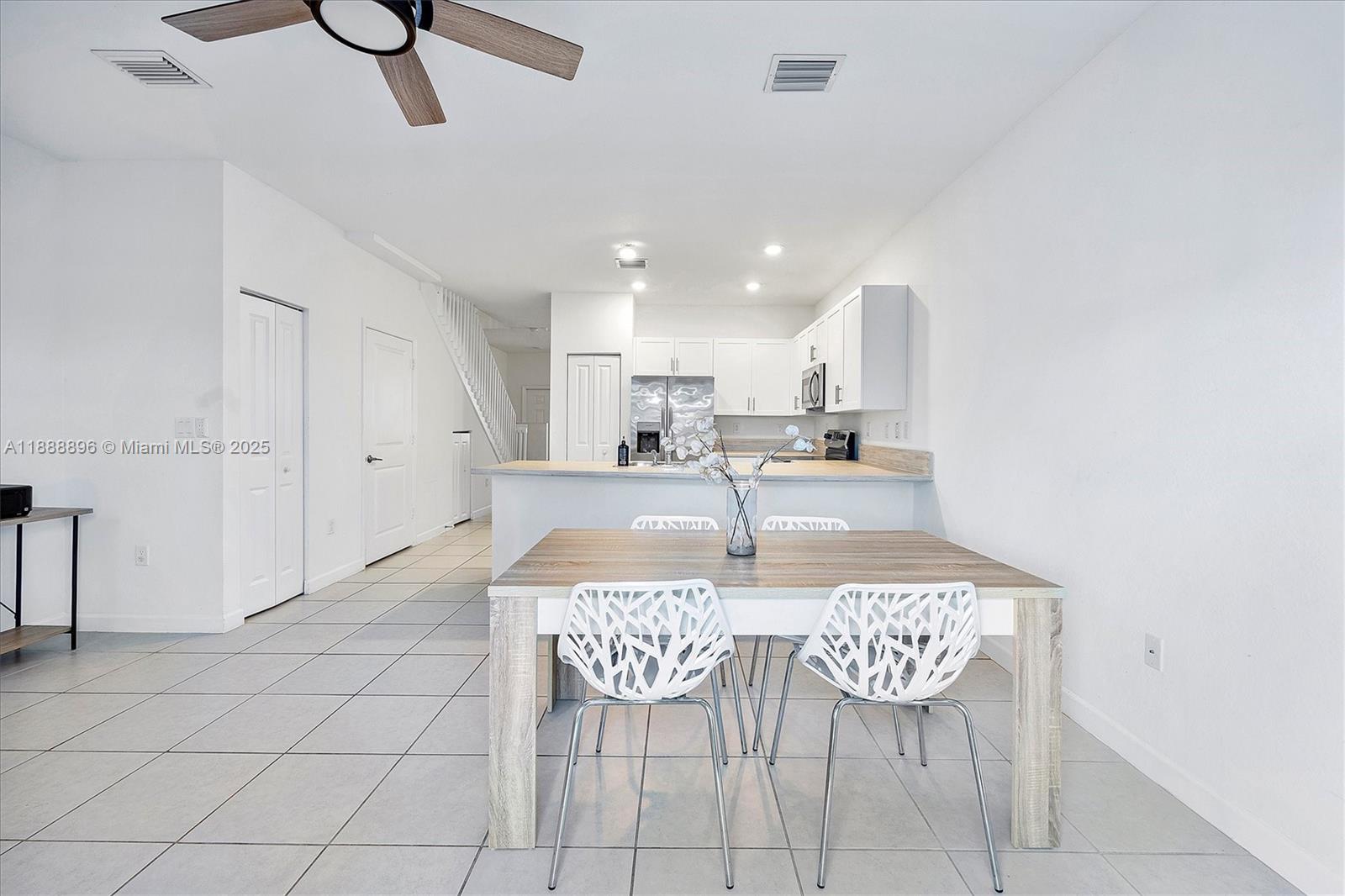 10013 Southwest 228th Terrace, Unit 10013 Miami, FL 33190 - Photo 11 of 39 a view of a dining room with furniture